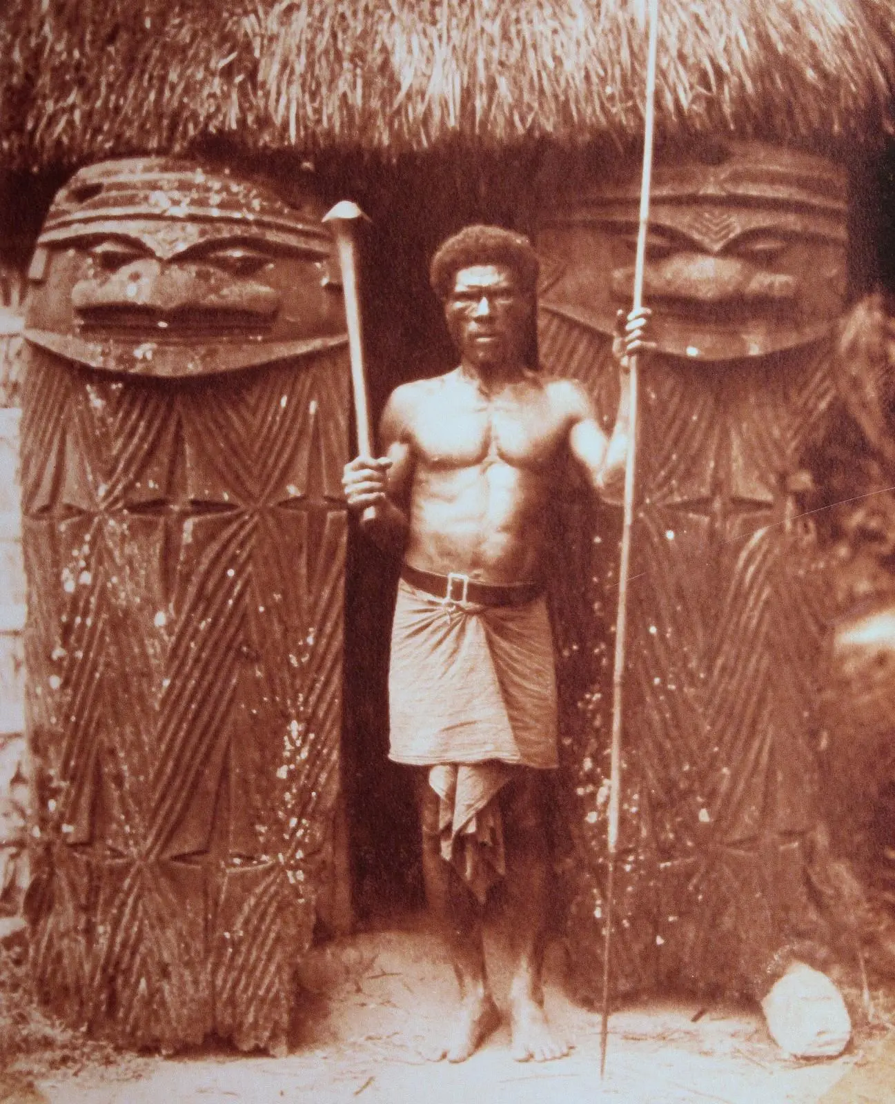 A man at the entrance of a ceremonial house, Région de Ouégoa, New Caledonia.  Photo : J.O. Haas, 1930 (Archives de la Nouvelle-Calédonie). 